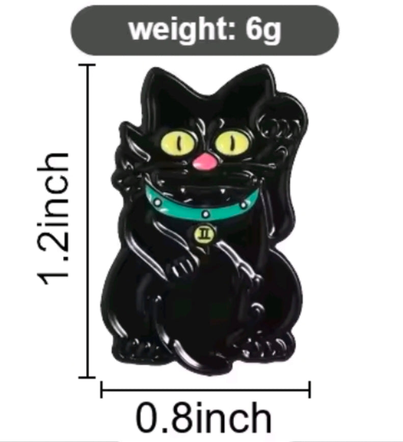 Black cat enamel pin with yellow eyes, teal collar, and skeleton-style face details
