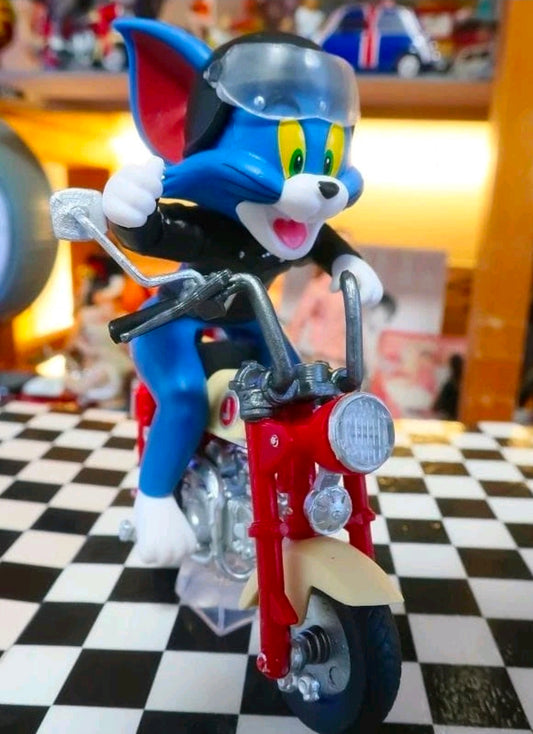 Biker Tom collectible figure on red motorcycle with black helmet and clear display stand