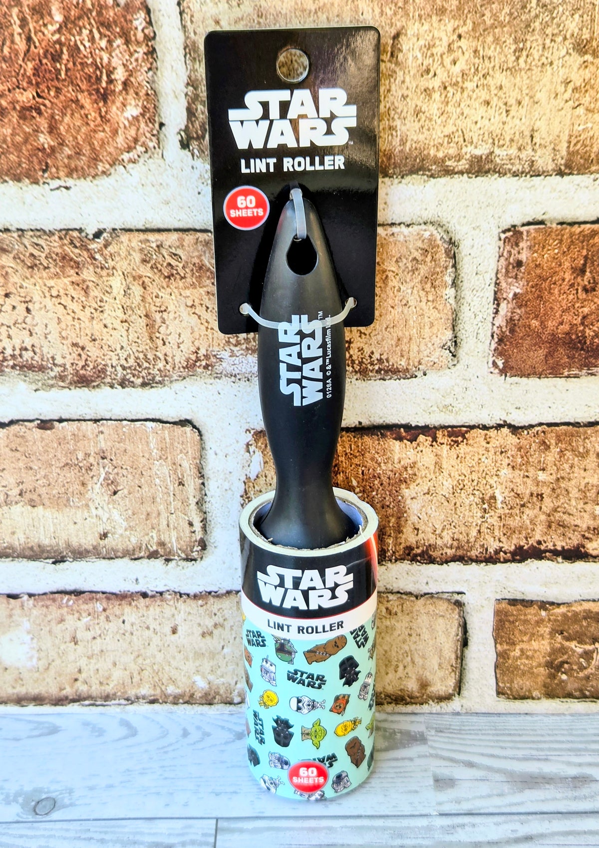 Star Wars lint roller packaging with black roller and 60-sheet label