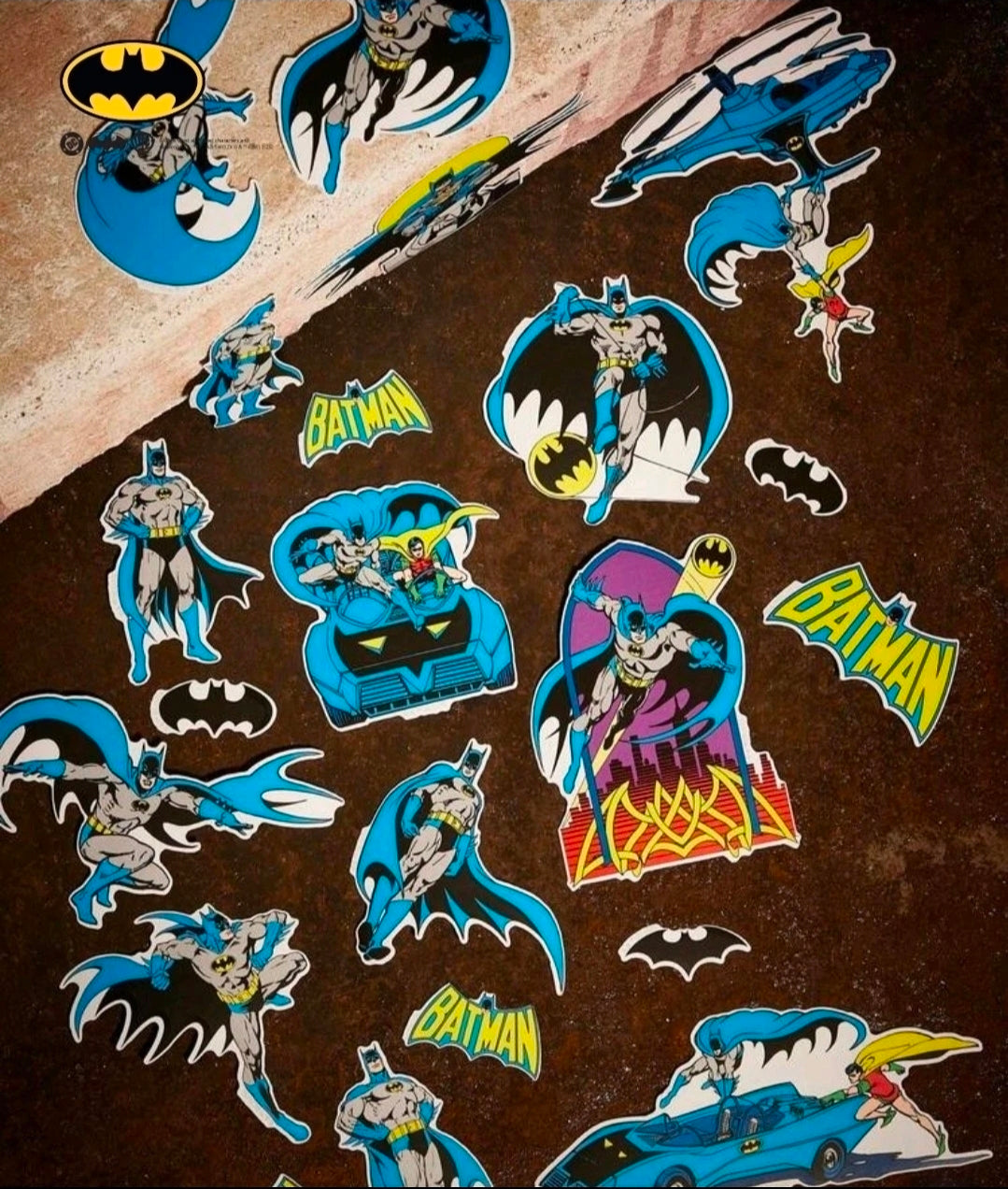 Batman character and bat logo stickers scattered in blue and black tones