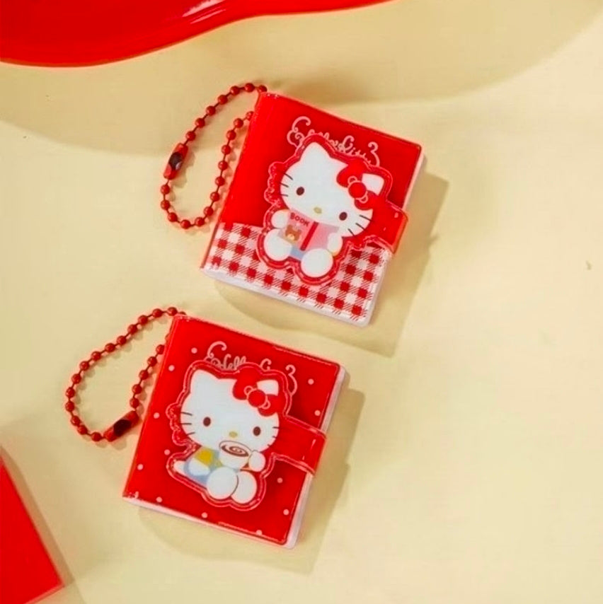 Two Hello Kitty mini note cards with red bows, checkerboard accents, and beaded chains