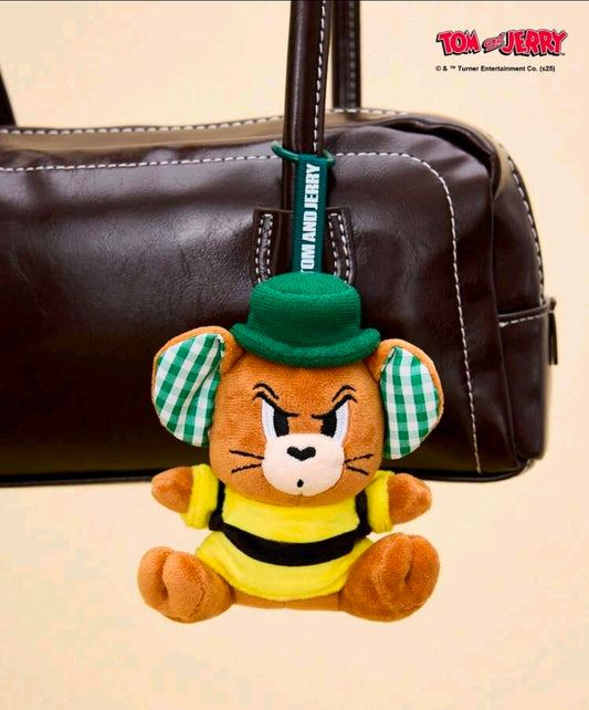 Tom & Jerry mouse mini plush keychain hanging from a brown bag, green hat