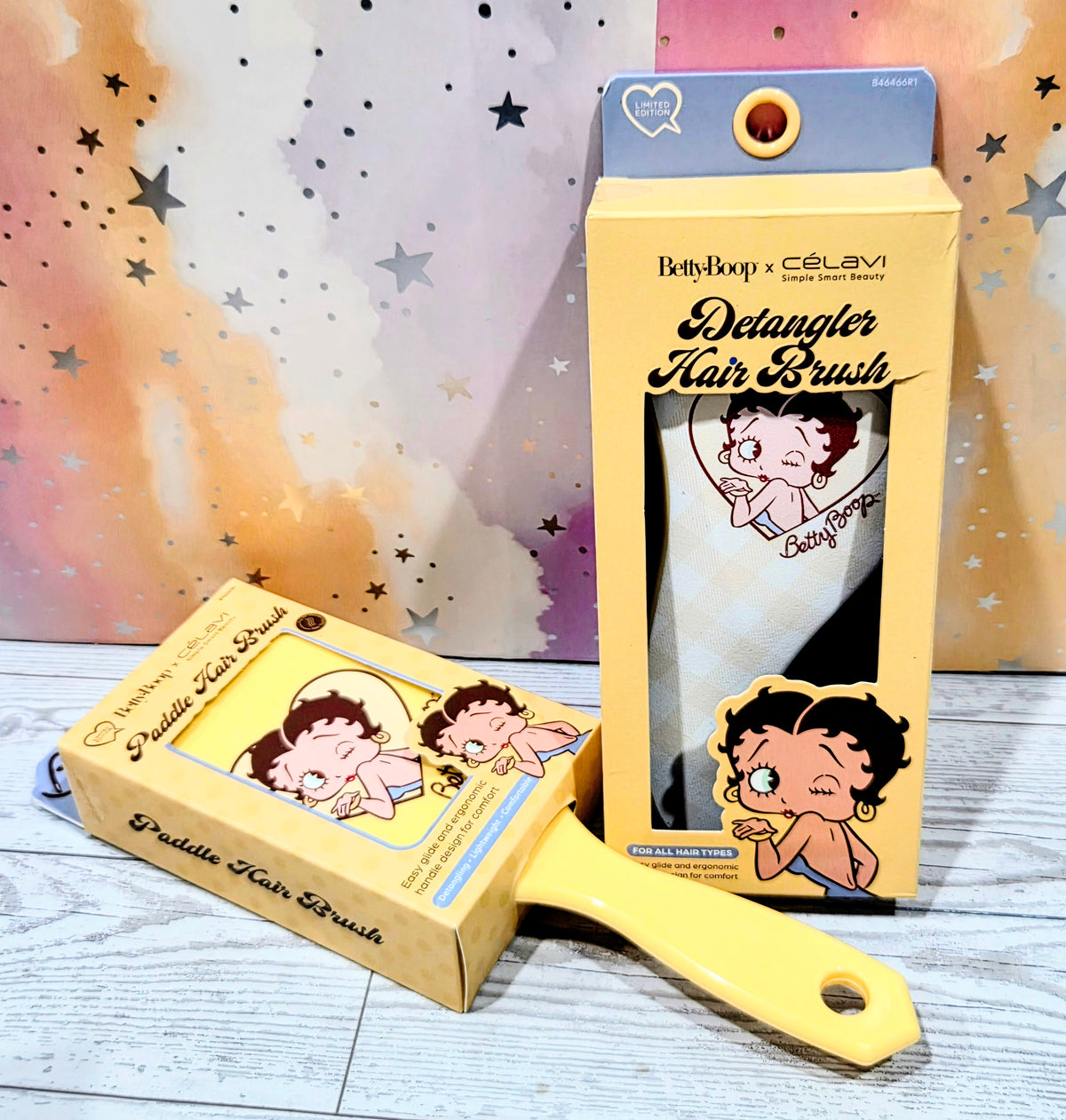 Detangler paddle hair brush with yellow handle beside packaged set, Betty Boop art