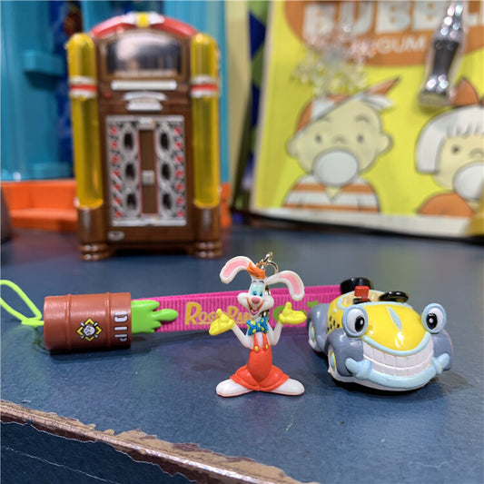 Benny Cab charm keychain with rabbit figure and toy cab lying on surface