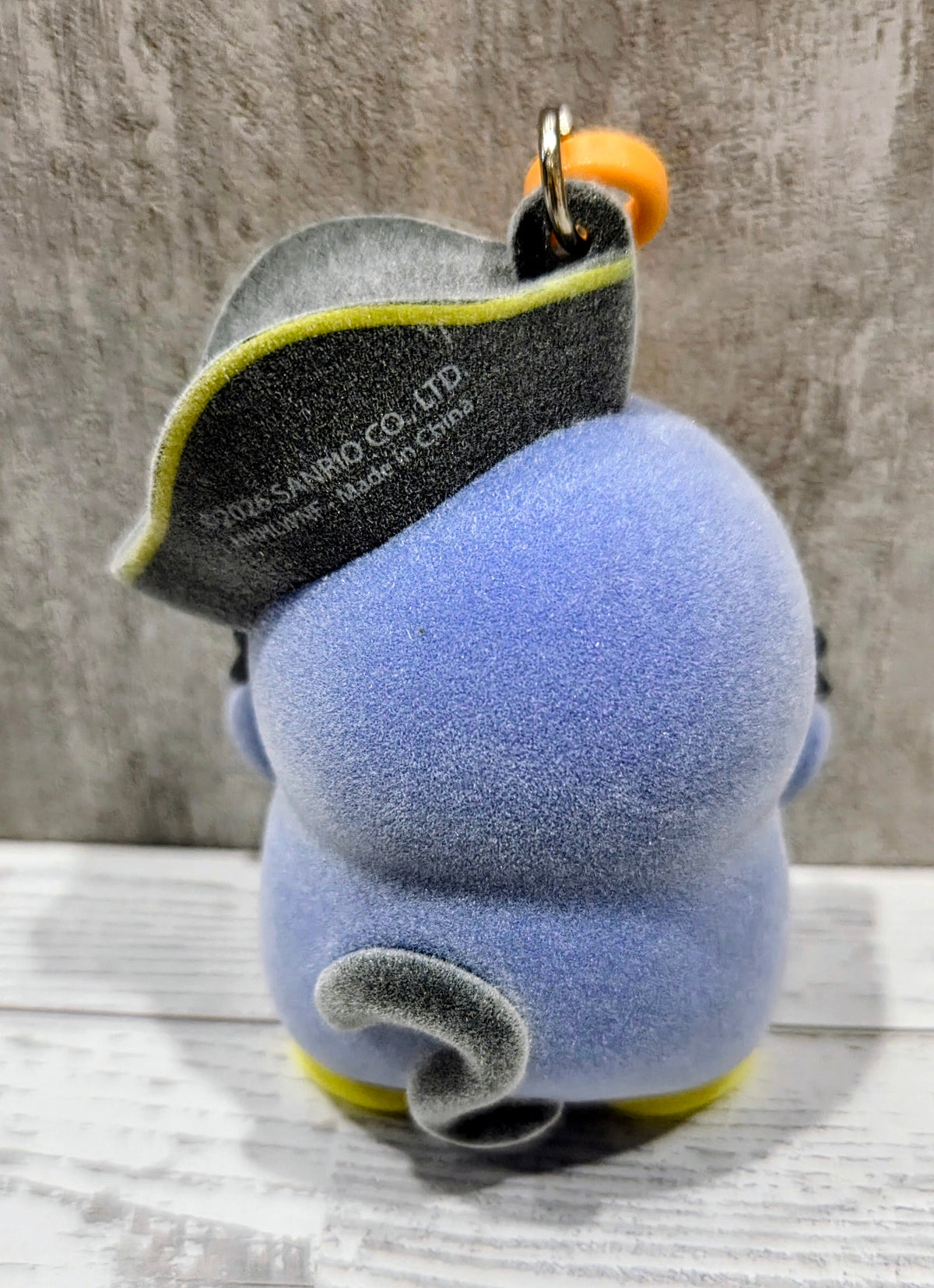 Blue Tuxedo Sam plush bag clip from back with pirate hat and yellow trim