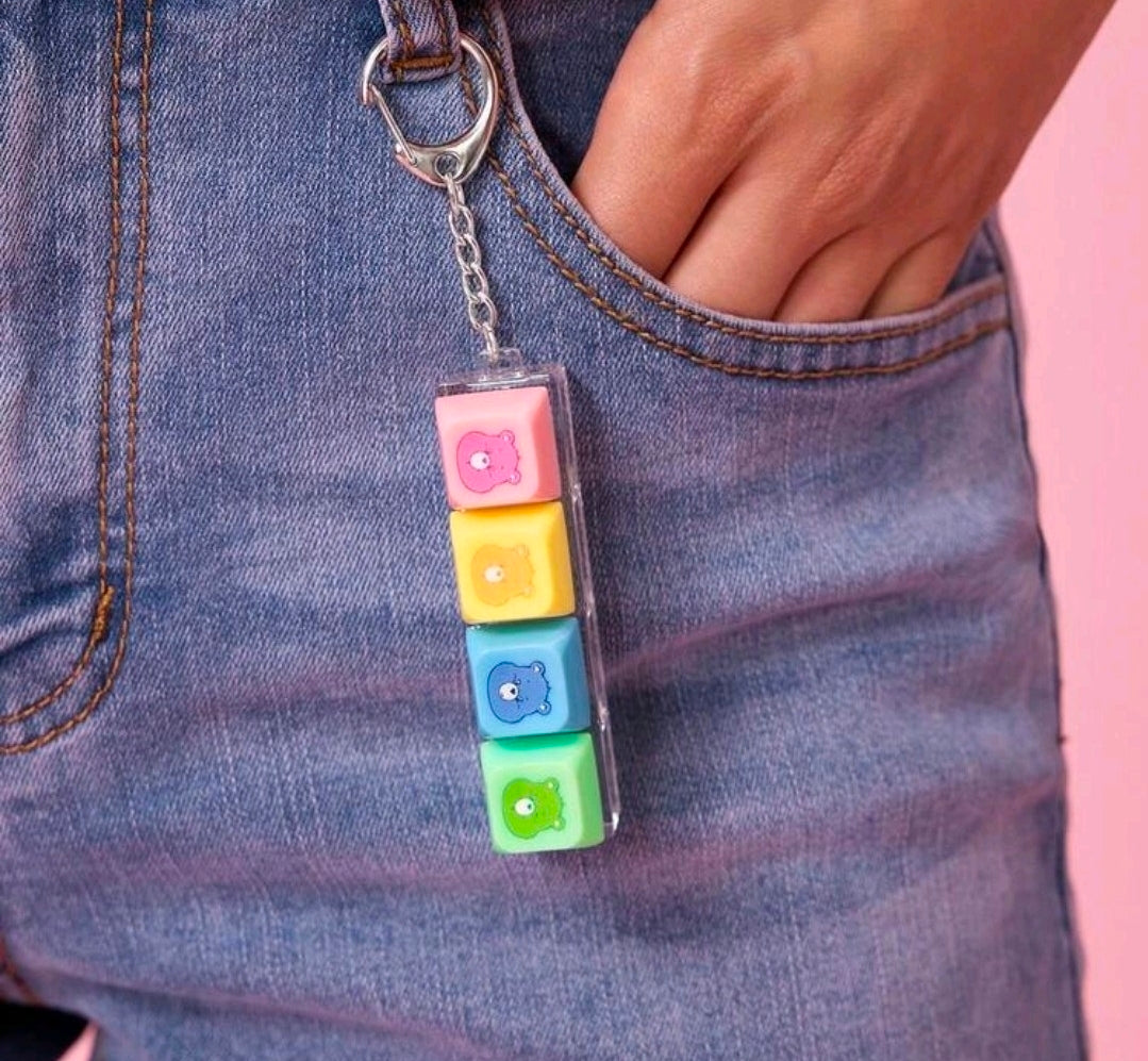 Keychain fidget blocks with four colorful Care Bears faces on a chain