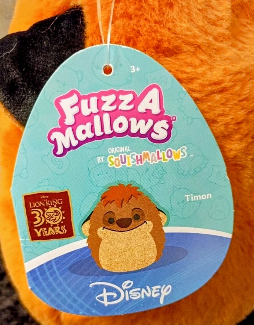 Orange Timon FuzzAMallow plush with hanging Disney 'Fuzz A Mallows' tag
