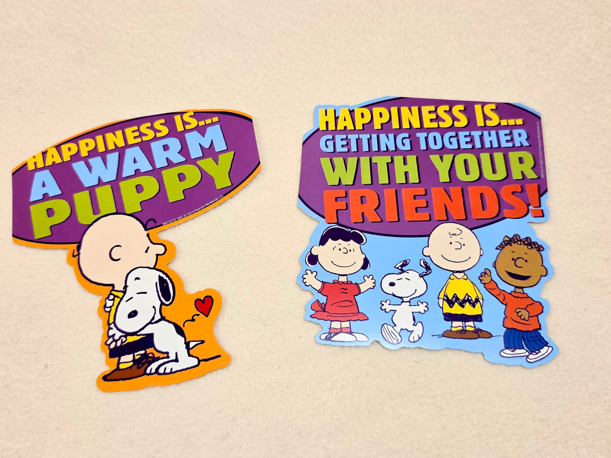 Two Peanuts wall decor cutouts with Charlie Brown, Snoopy, and a heart: "WarM PUPPY" and "friends"