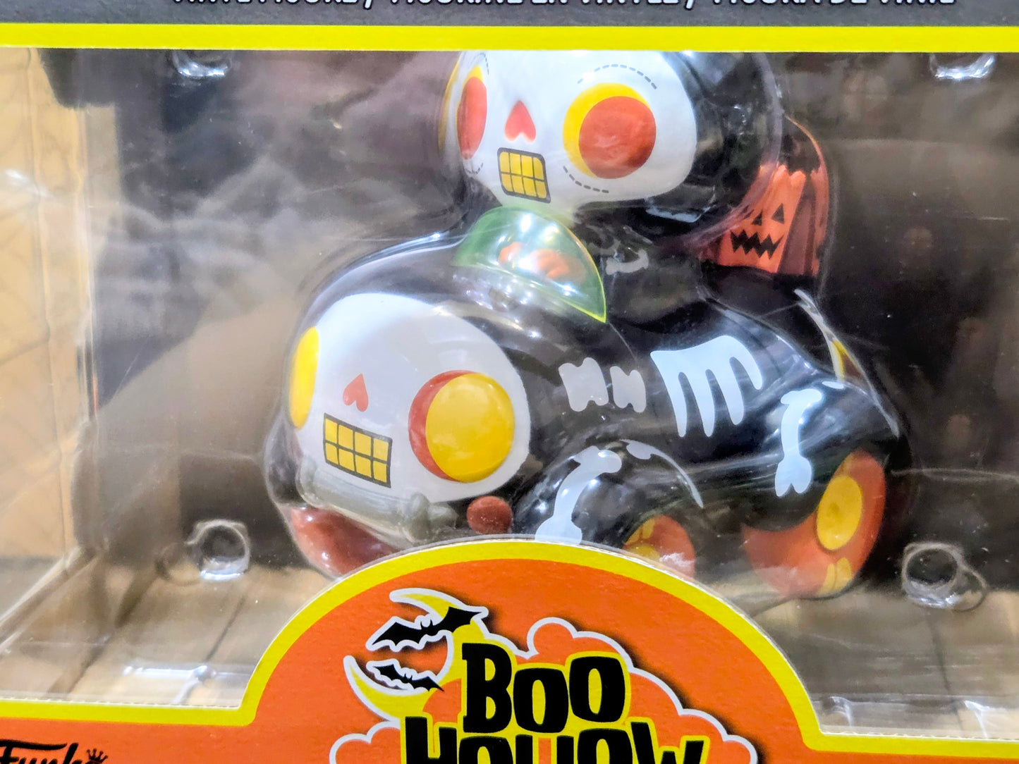 Vinyl collectible buggy figure with black, white, and orange skull-face design