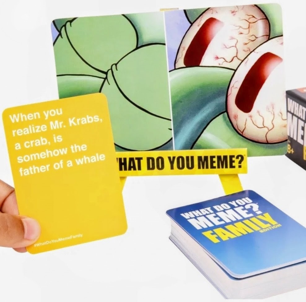 Hand holding an orange prompt card for SpongeBob SquarePants card game