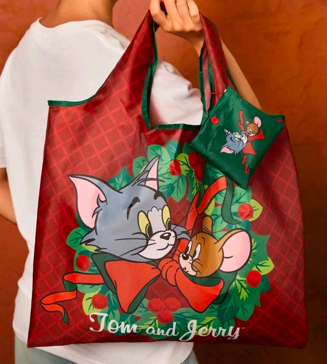 Reusable tote bag with red plaid and green character panel; snaps pouch side pocket.