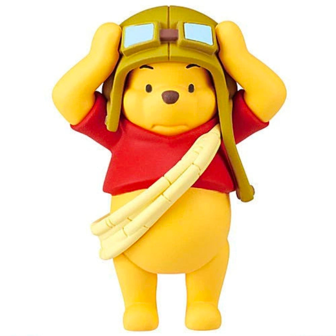 Winnie the Pooh character figure in red outfit with tan bandaged arm and tan hat