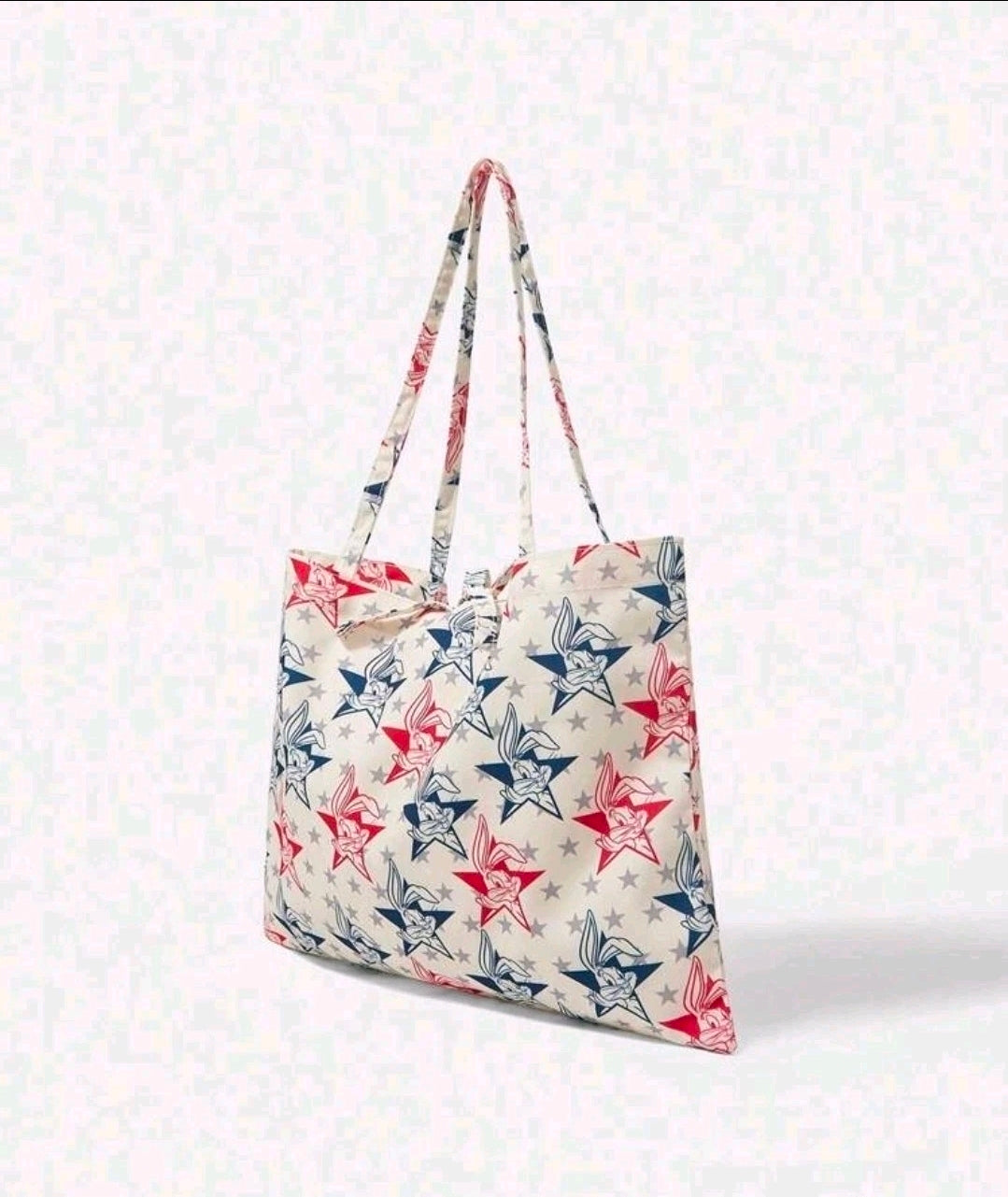 Star and cartoon bunny print tote bag with long handles, side view