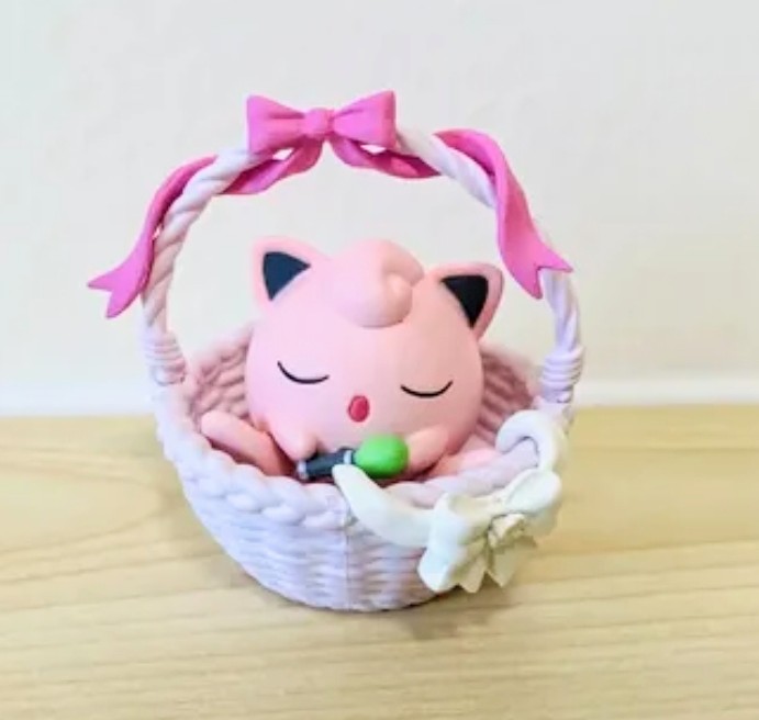 Jigglypuff nap basket figure with pink body, closed eyes, and soft white blanket.