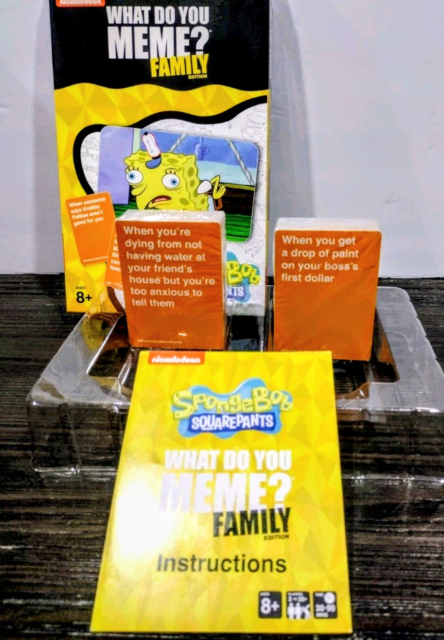 What Do You Meme? Family card game box with instructions and orange cards