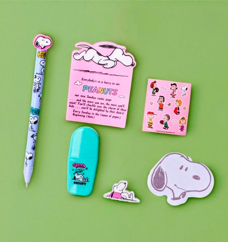 Snoopy stationery set flat lay with decorated pen, small sticky notes, stickers, eraser.
