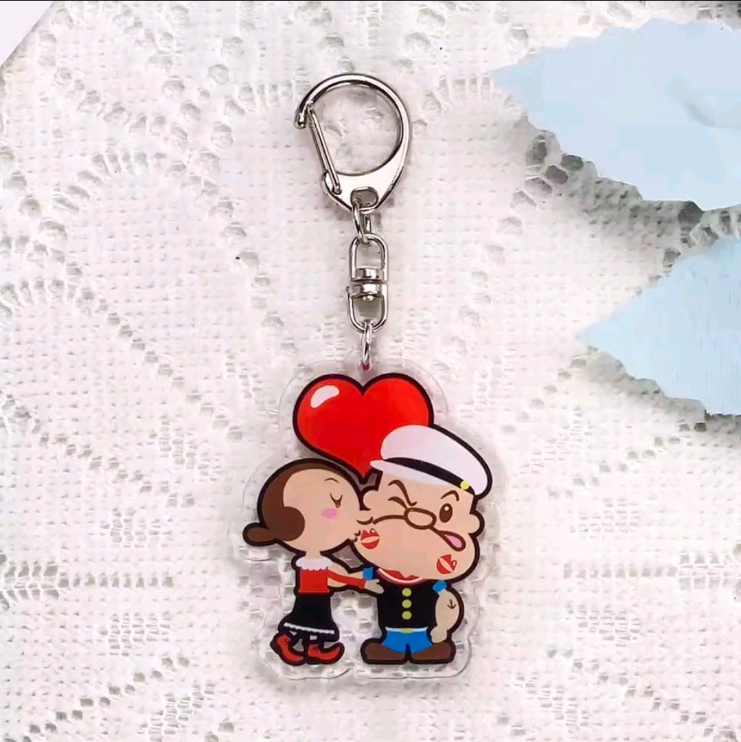 Acrylic keychain charm featuring Popeye and Olive Oyl with a red heart above them