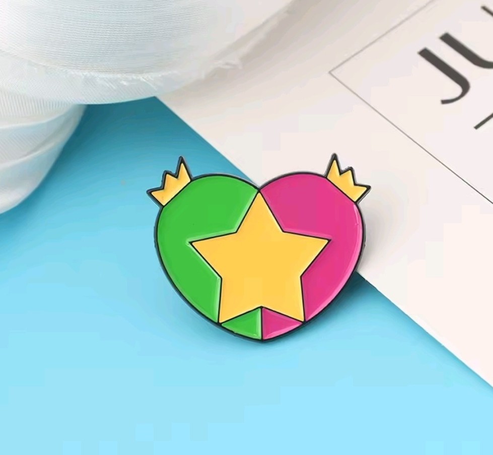 Enamel pin of a heart-shaped star with green, yellow, and pink sections.