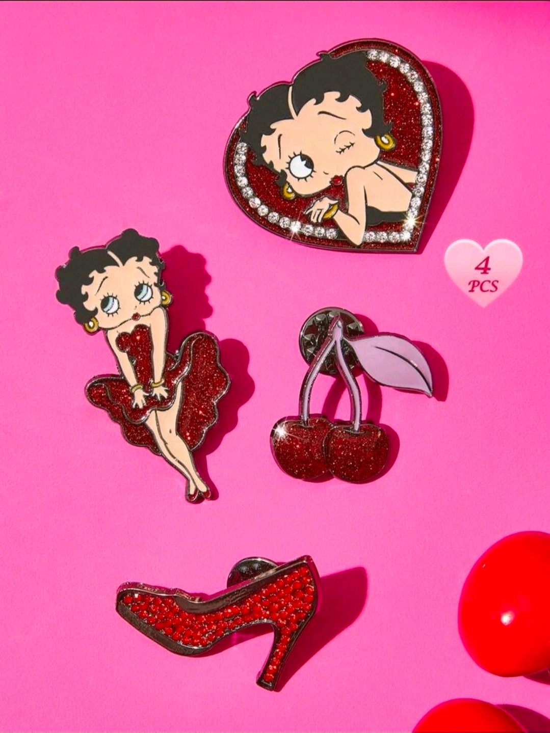 Four glitter rhinestone enamel pins: Betty Boop heart portrait, standing figure, cherries, and high heel