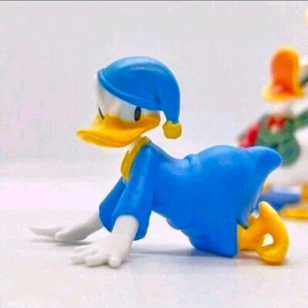 Donald Duck costume figure lying down in blue outfit with light-blue cap and yellow shoes