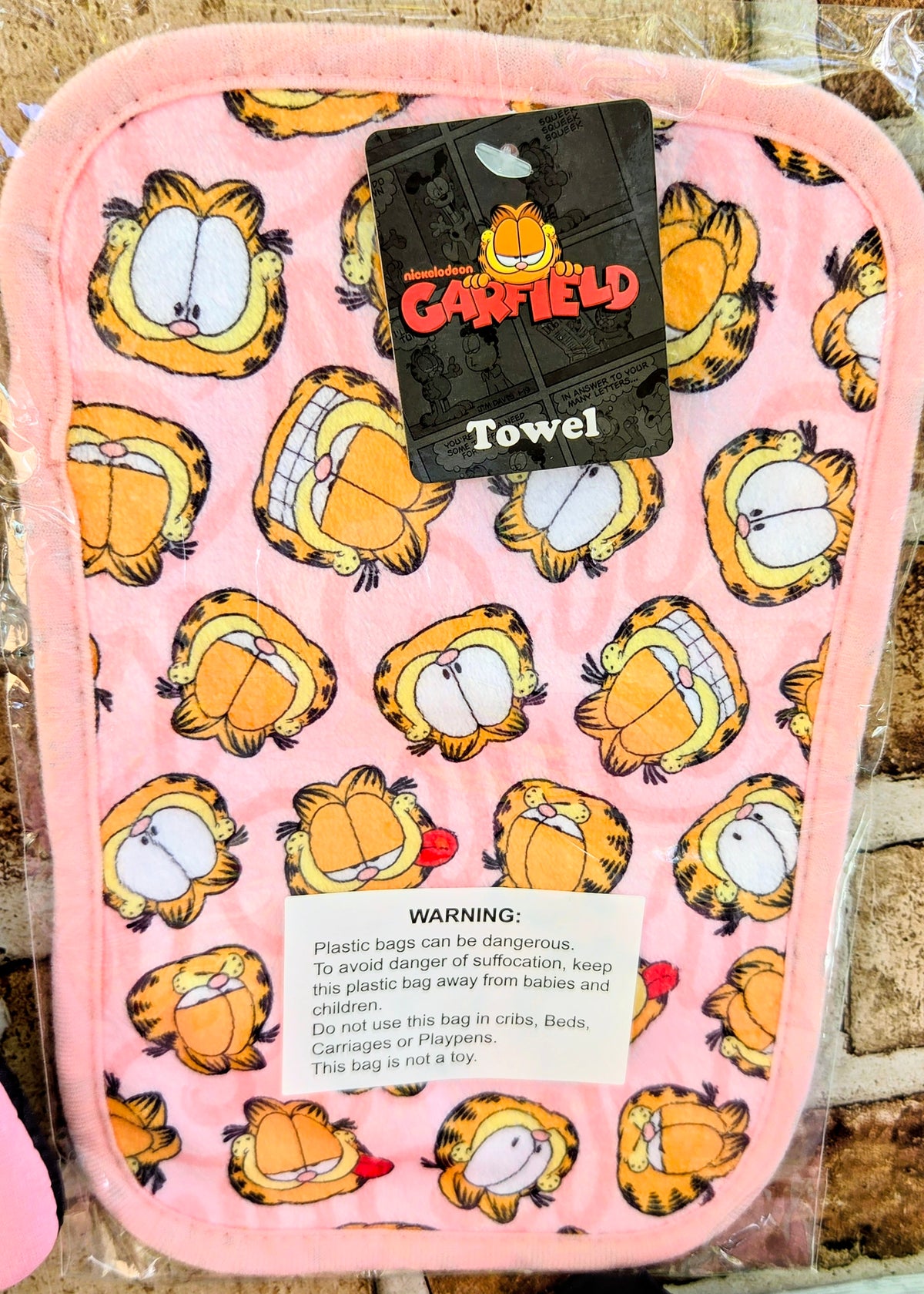 Pink Garfield and Odie oven mitt with printed cartoon pattern and warning label
