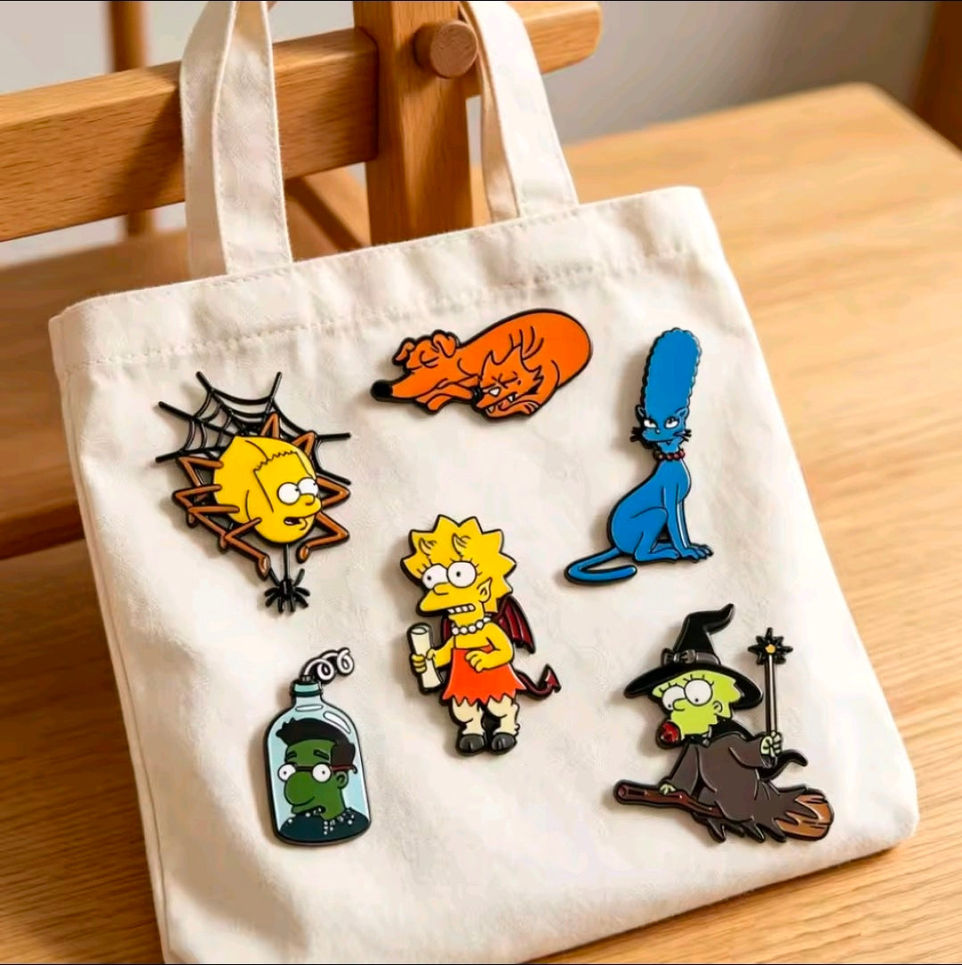 Halloween enamel pin set with six colorful character pins on a white tote bag
