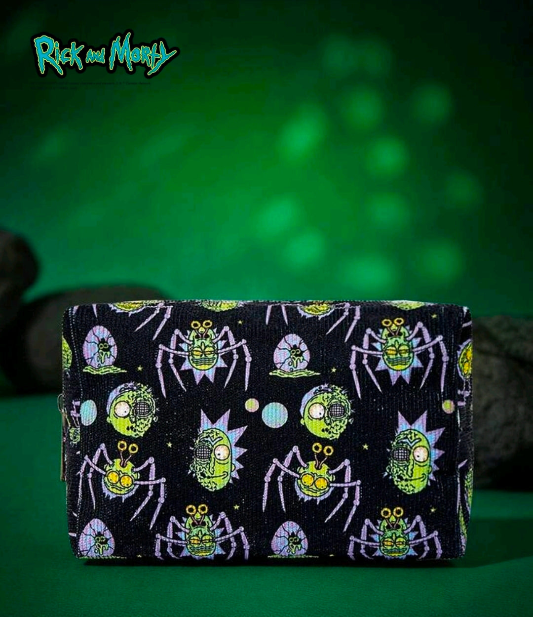 Rectangular black makeup bag with zipper and multicolor sci-fi character pattern.