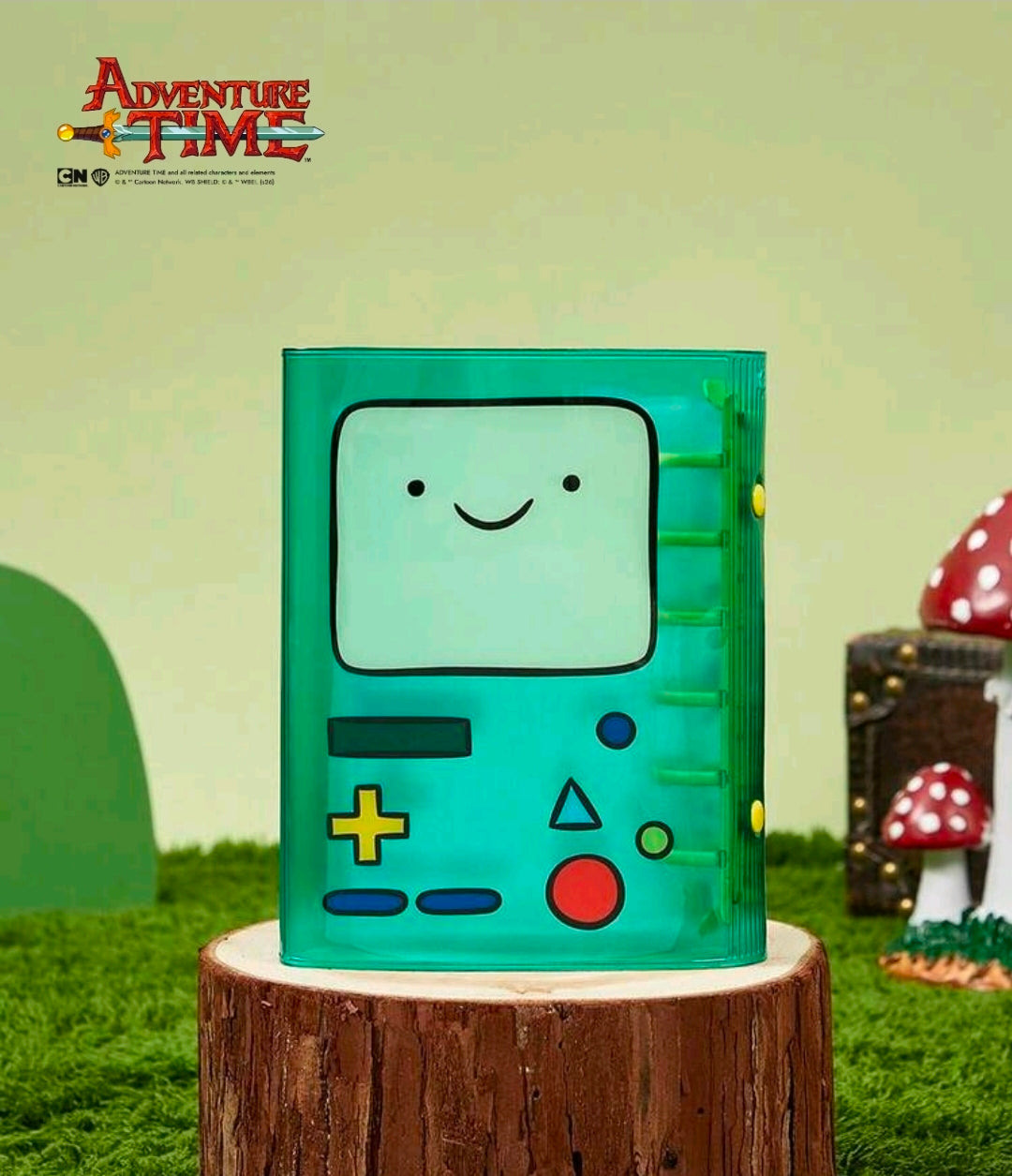 Green A7 mini binder front with smiling BMO face and game button symbols.