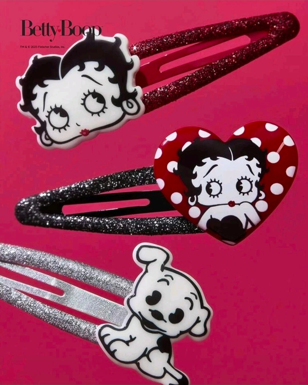 Close-up of glitter hair clips with cartoon faces and red polka-dot heart accents