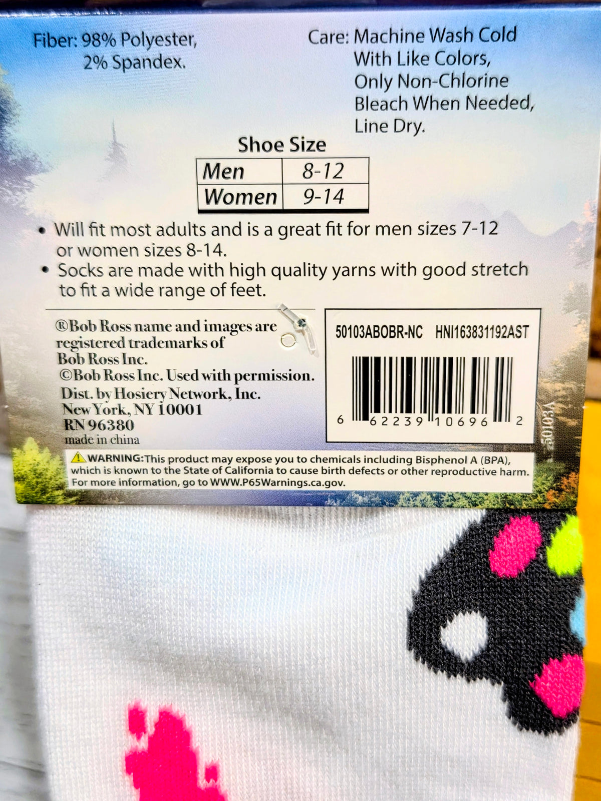 White crew sock with black face graphic and multicolor paw prints near cuff