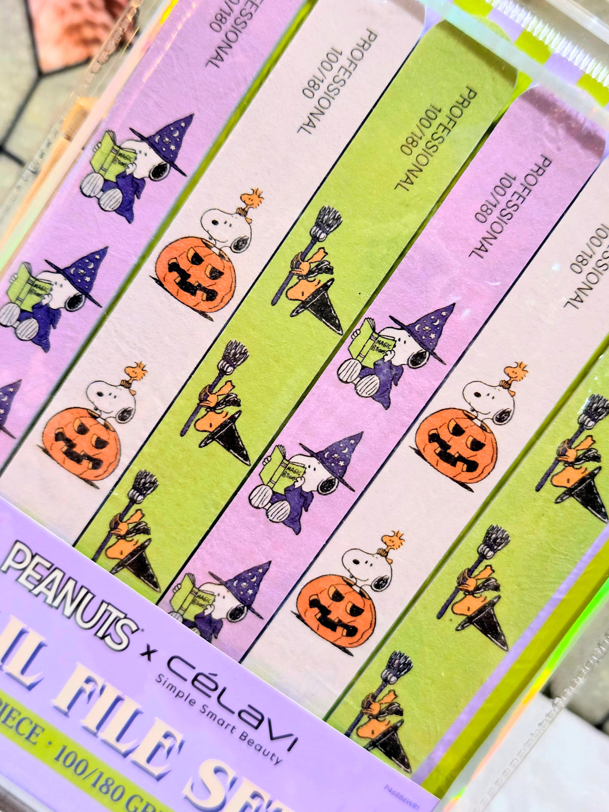 Close-up of colorful nail file strips with Snoopy, pumpkin, and witch character drawings