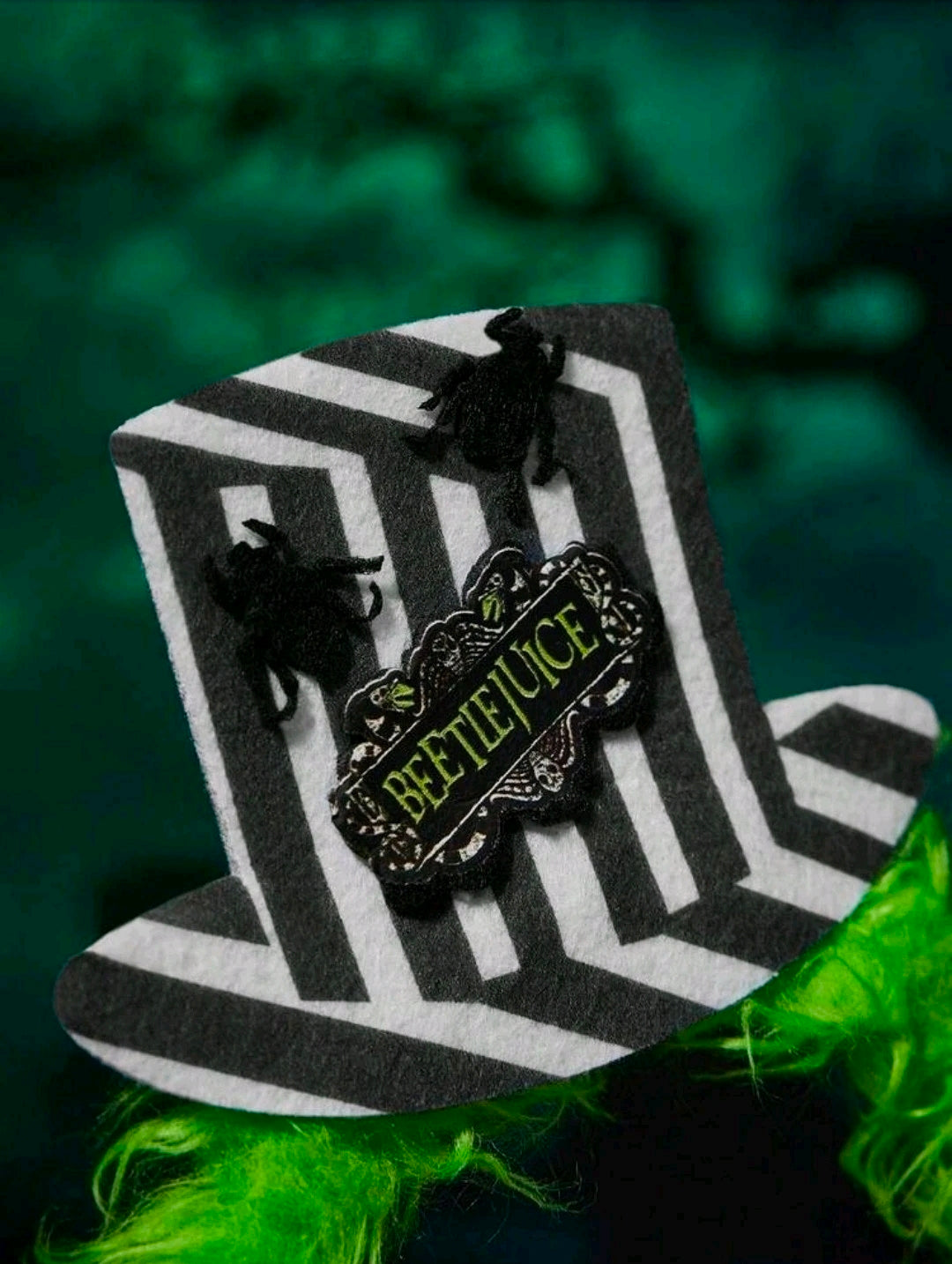 Green fur Halloween headband with black-and-white mini top hat and Beetlejuice badge
