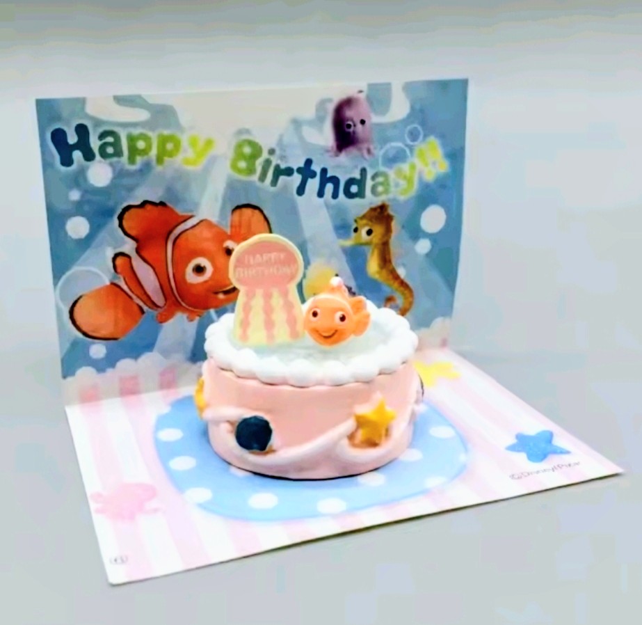 Birthday ocean cake mini figure on display with clownfish and “Happy Birthday” banner