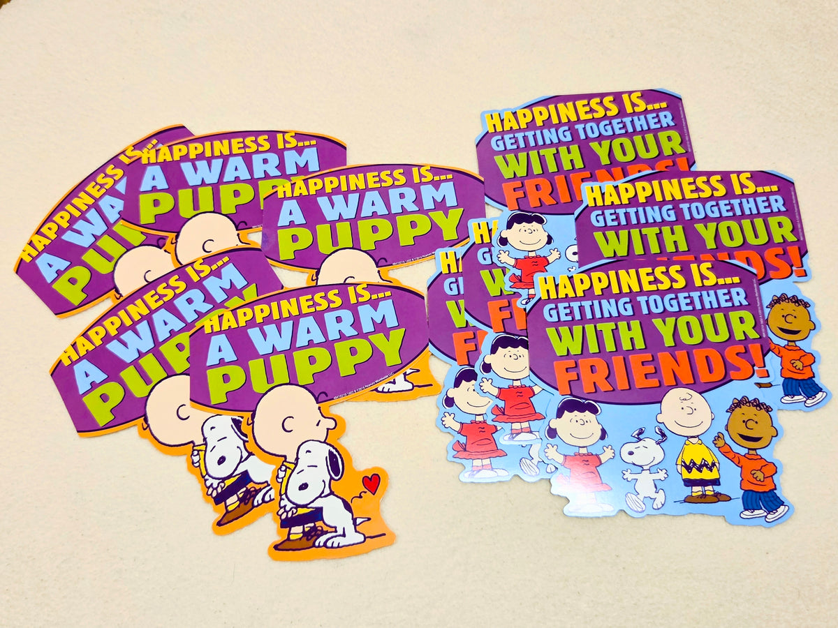 Assorted Peanuts wall decor cutouts in purple and blue with Snoopy and friends text designs