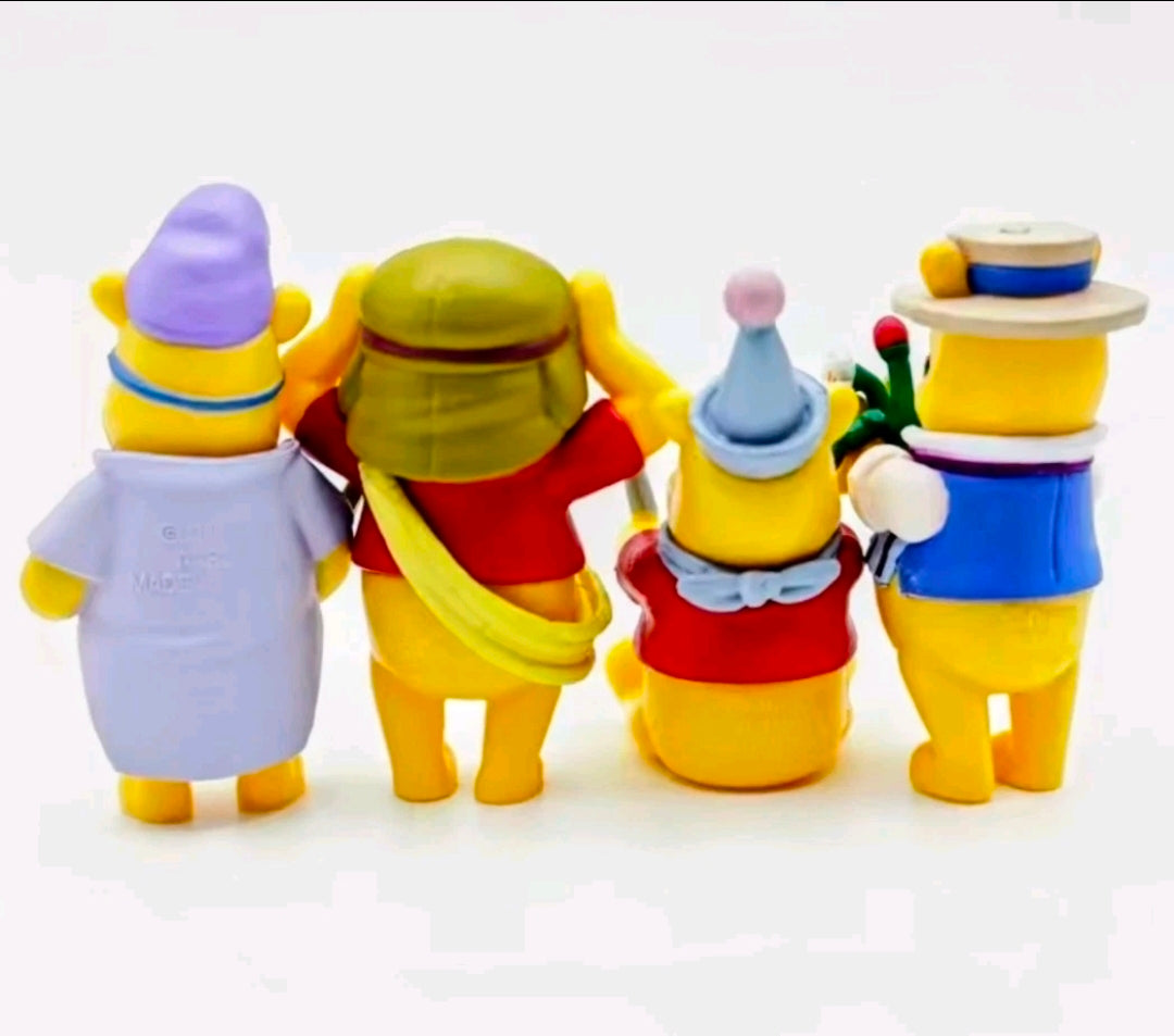Four Winnie the Pooh character figures standing together, colorful outfit details visible