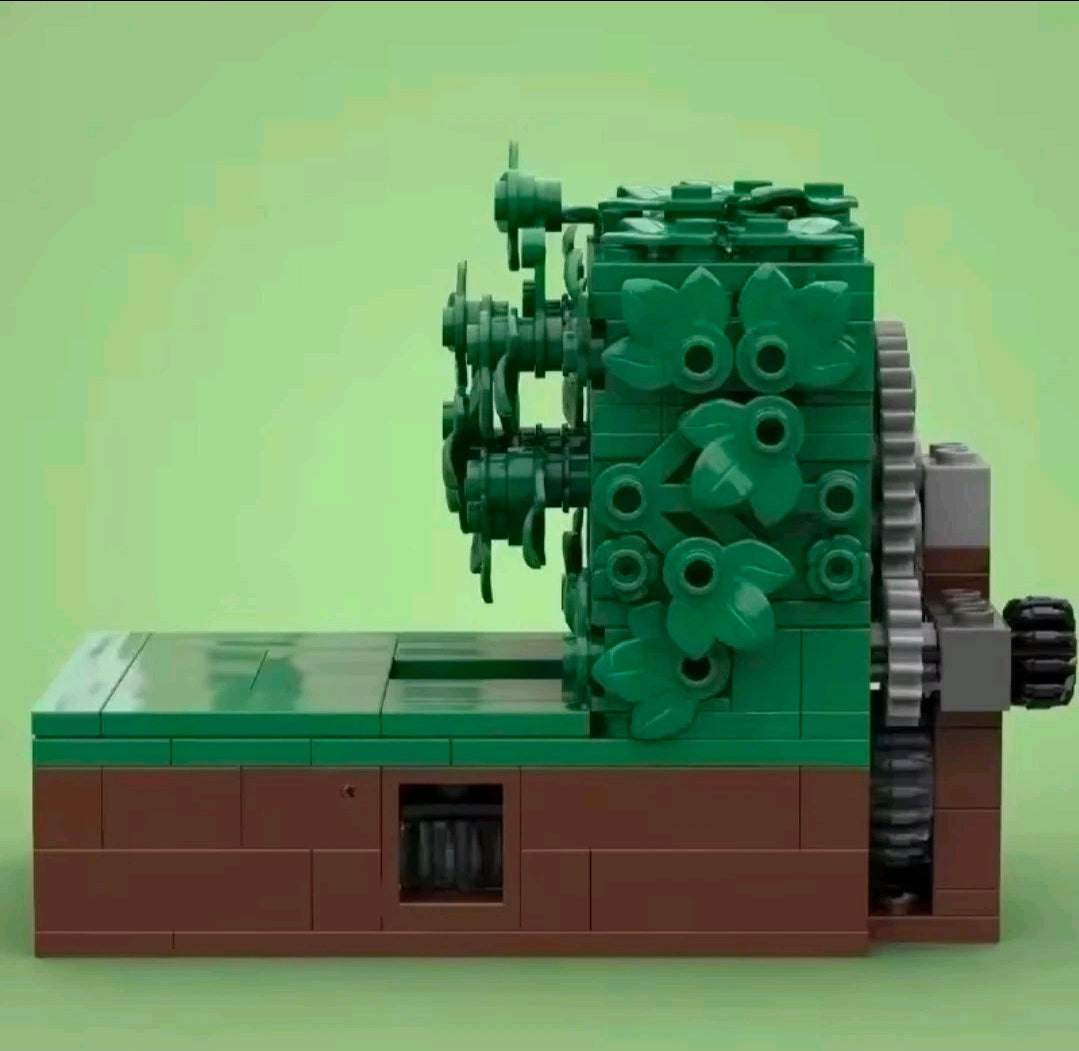 Brick build playset with dark green foliage cover, brown base, and side gray gears.