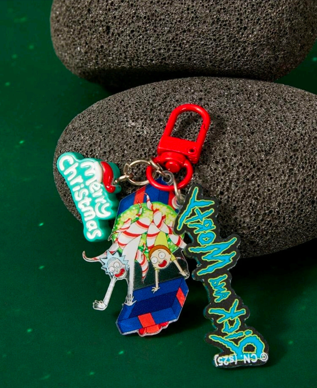 Red carabiner keyring with Santa elf charm, Rick script, and small Morty logo charm