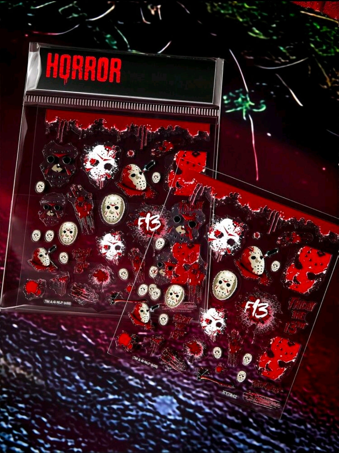 Packaged horror nail art sticker sheets showing red-and-white character and symbol decals