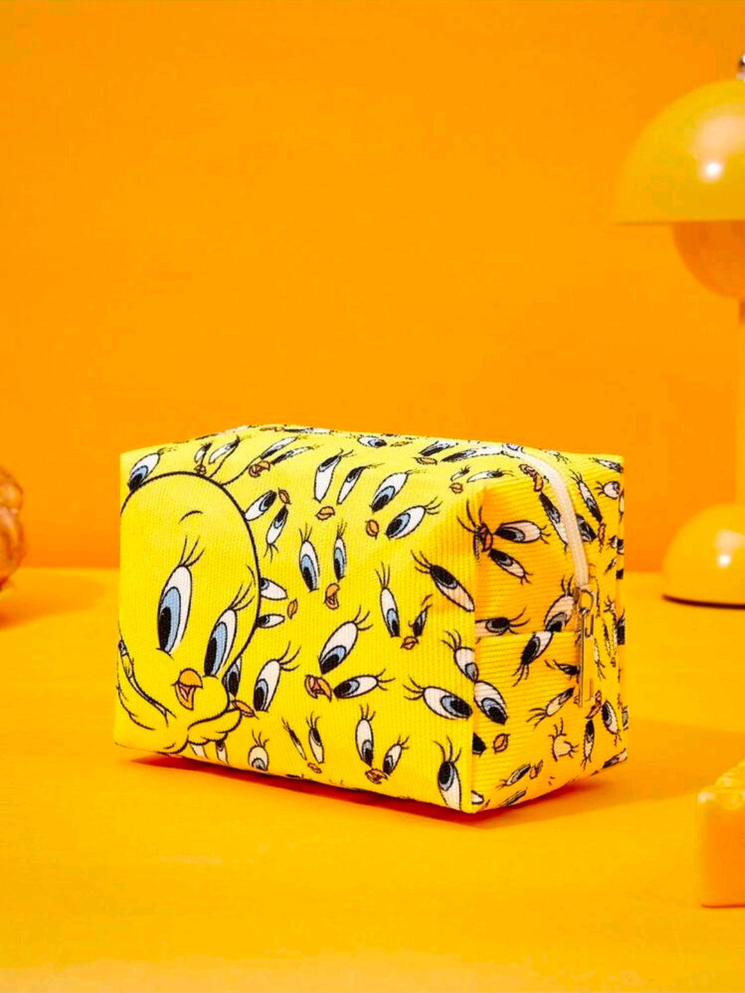 Yellow rectangular makeup bag with repeating Tweety face pattern