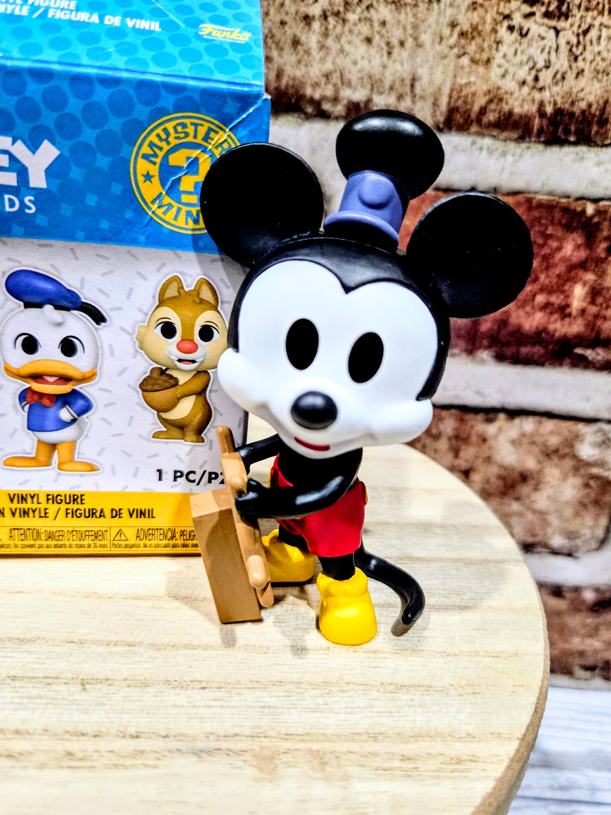 Mickey Mouse mini vinyl figure standing in front of a mystery minis box