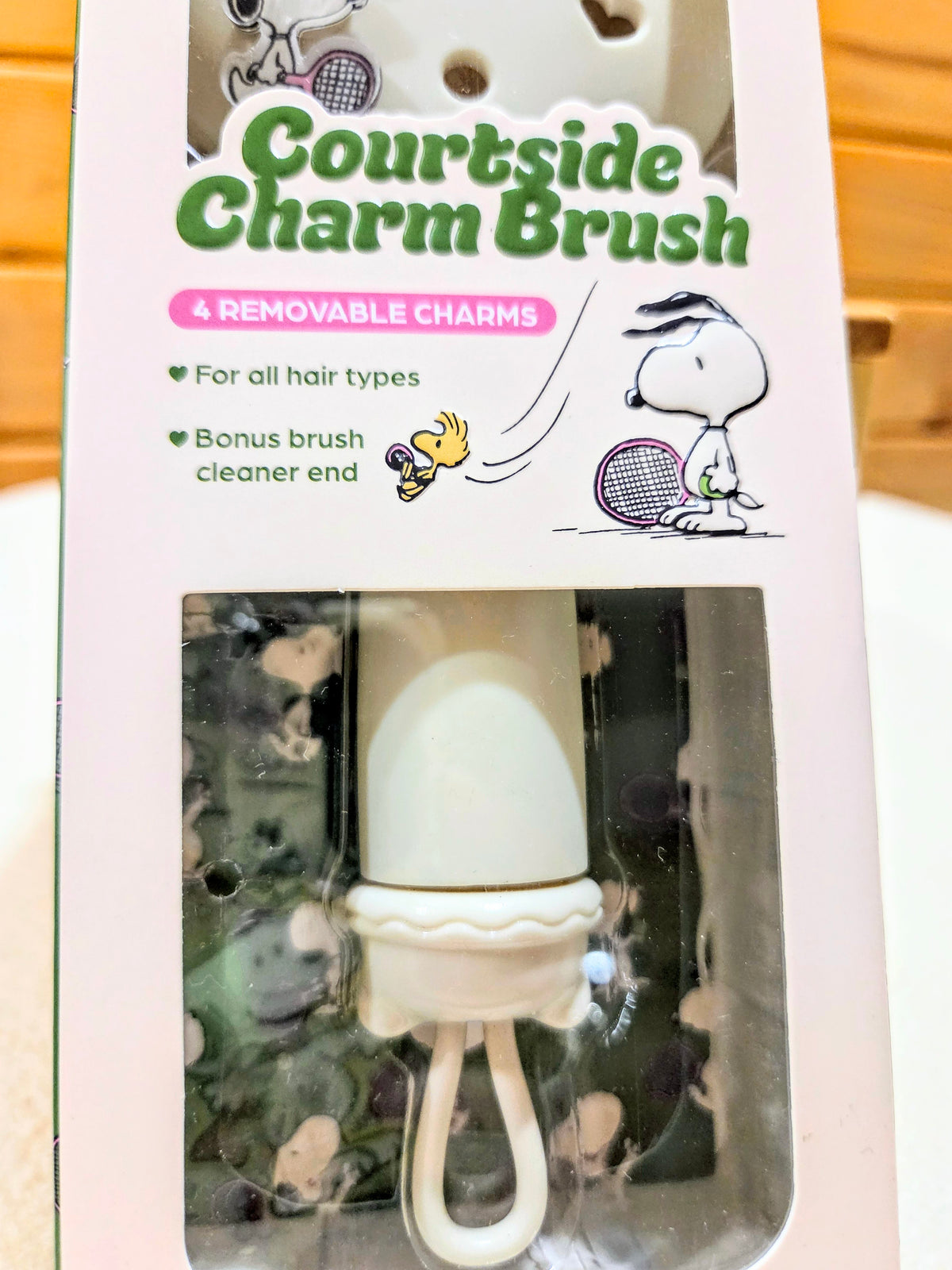 Charms hairbrush box back showing removable charms and a brush-cleaner end