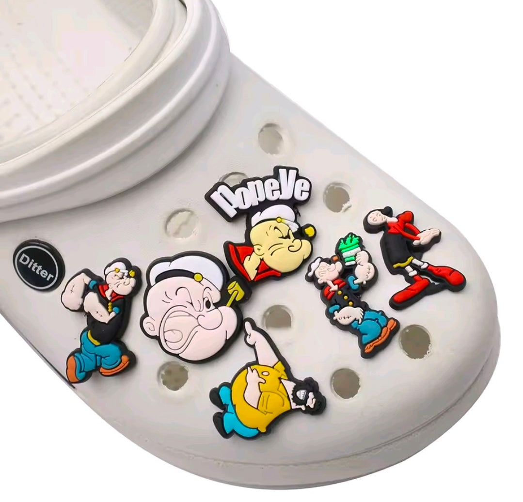 Popeye PVC shoe charms on a white clog, with multiple characters and the logo