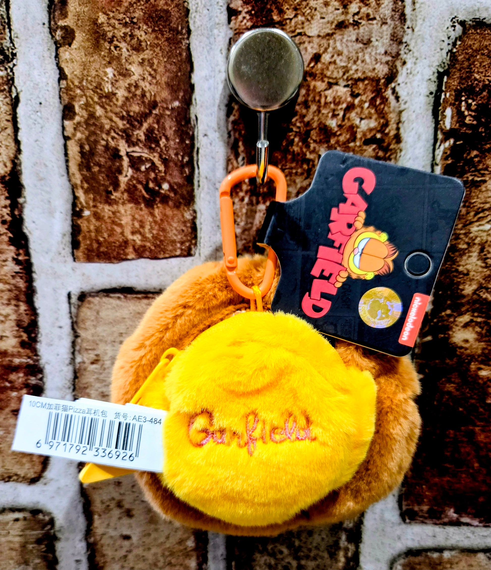 Garfield pizza plush coin pouch with yellow flap, orange handle, and back tag