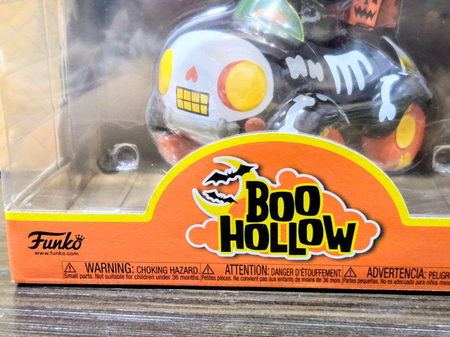 Vinyl figure in clear blister packaging for Boo Hollow with skull-faced buggy