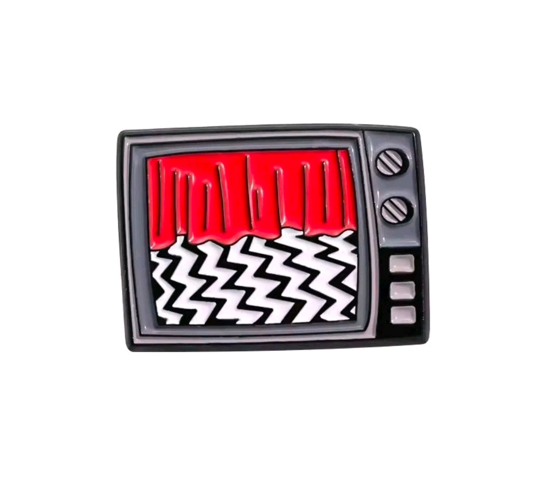 Enamel TV screen pin with red vertical shapes and white zigzag lines on black.