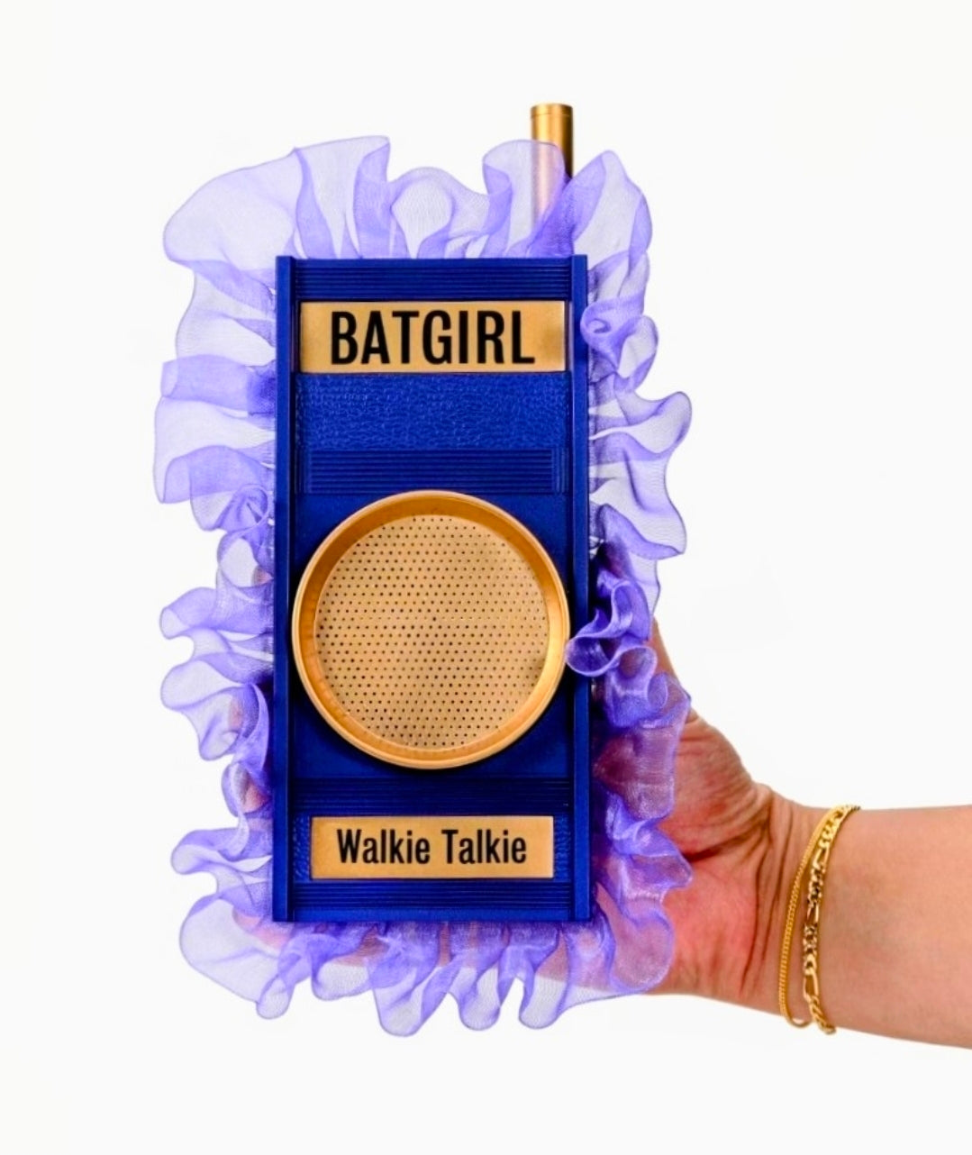 Batgirl walkie talkie prop replica held in a hand, front panel with gold speaker