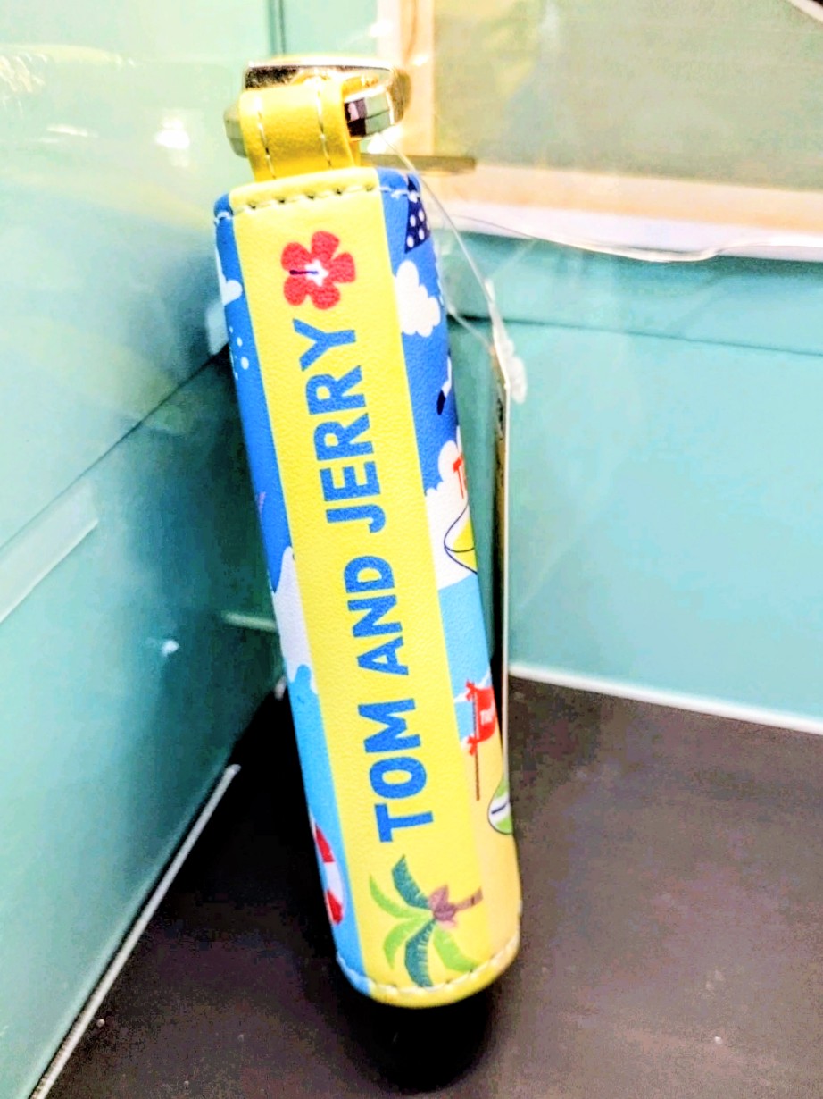 Blue smart key case with yellow zipper pull and cartoon “Tom and Jerry” graphic