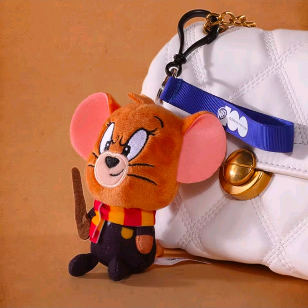 Orange wizard plush keychain on a white sneaker, with blue strap and gold bell charm