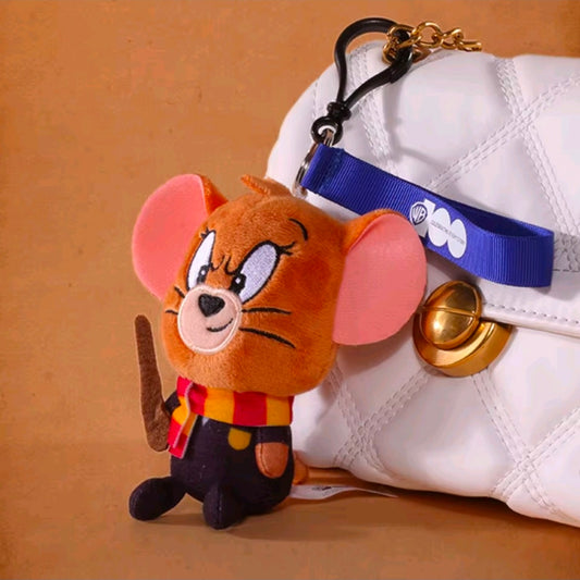 Orange wizard plush keychain on a white sneaker, with blue strap and gold bell charm