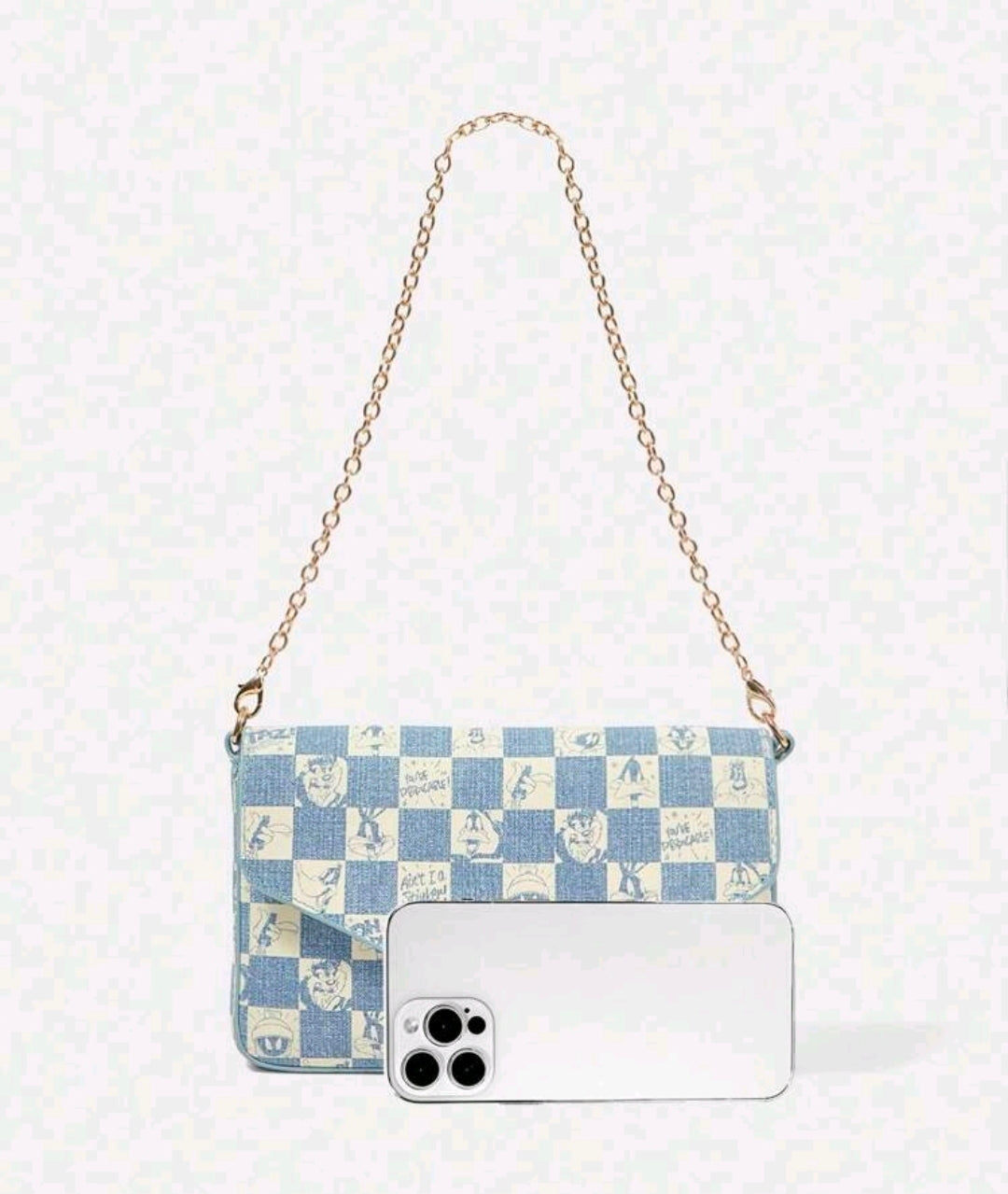 Denim blue patchwork shoulder bag with gold chain strap and front flap.